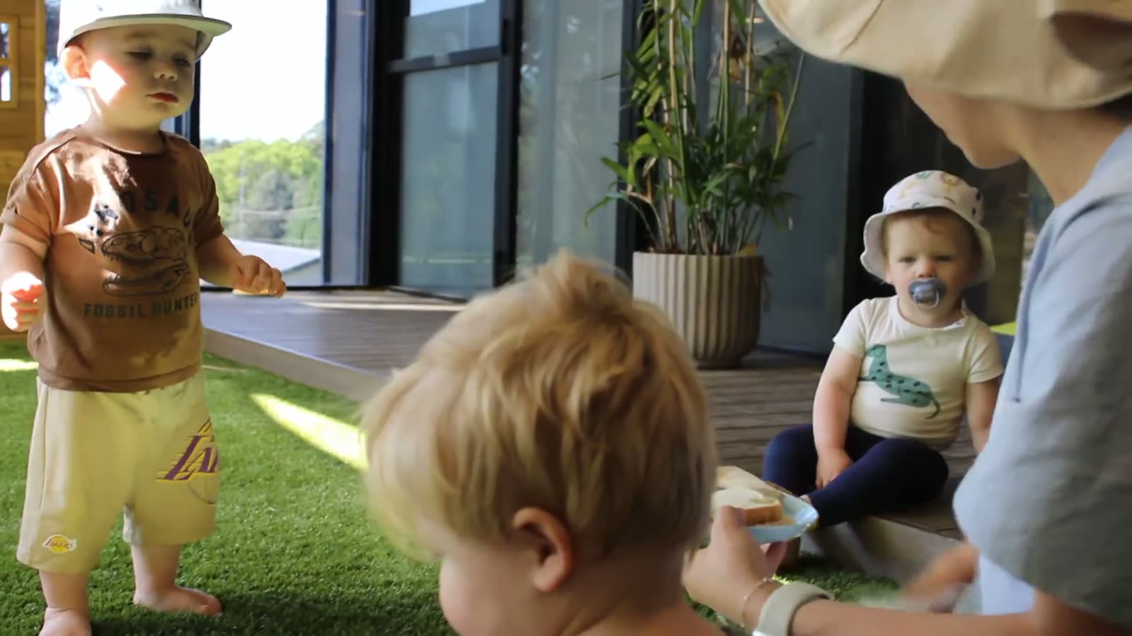 Toddlers playing on the grass deck