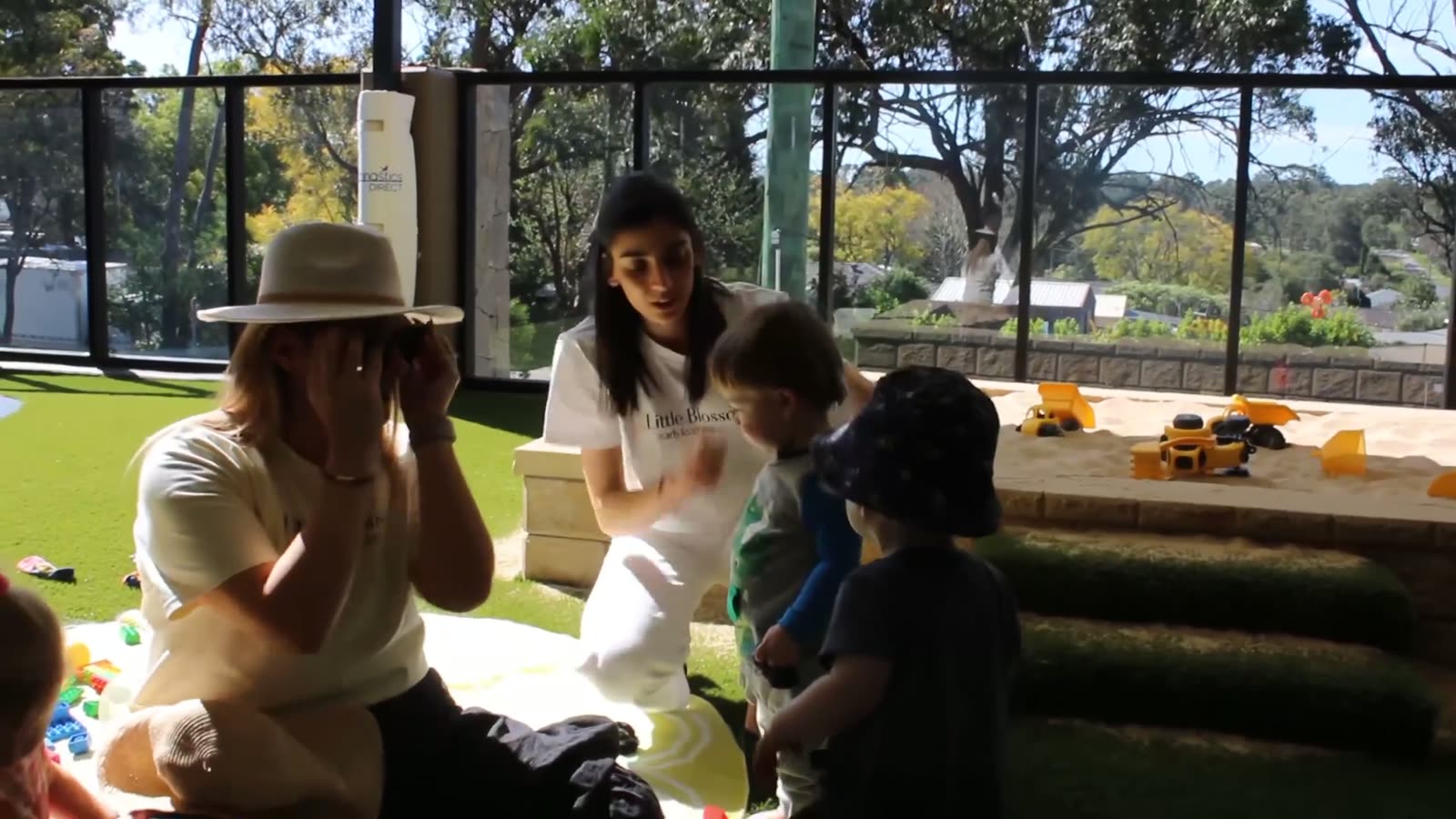 Educators and children together in the outdoor garden